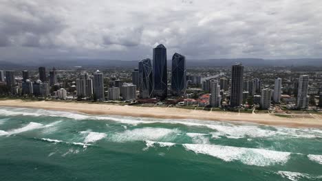 the crystal-like jewel towers, home to the langham hotel and jewel residences, rise along the beachfront in gold coast, queensland, australia - orbit drone shot