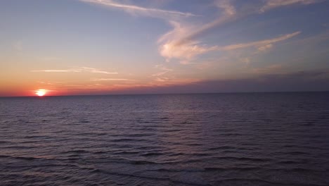 Drone-footage-of-a-sunset-over-Baltic-Sea,-Lubiatowo-Beach,-Poland