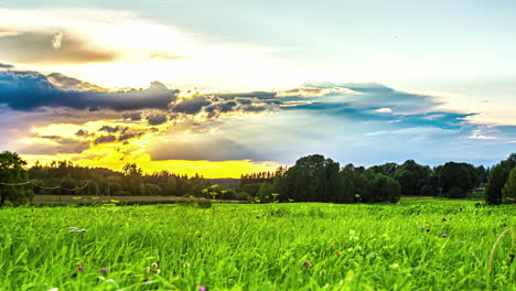 a sunset starts sunny and is later covered by storm clouds as the sun continues to set