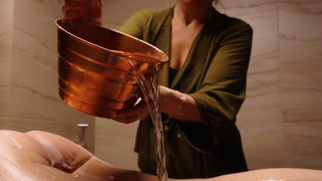 ayurvedic body treatment with copper bowl