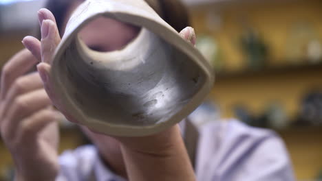 woman handbuilding a hollow clay tube