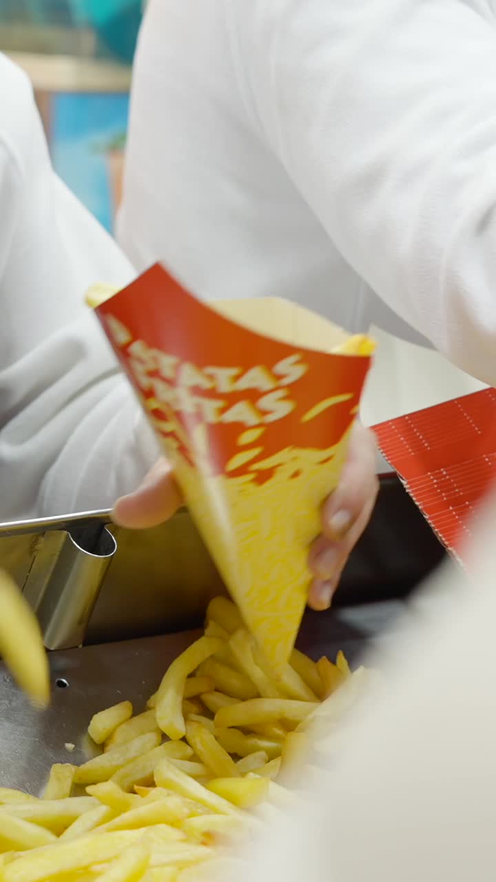 Serving Freshly Cooked French Fries into a Cone