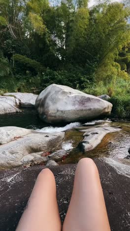 relaxing by a stream in the woods