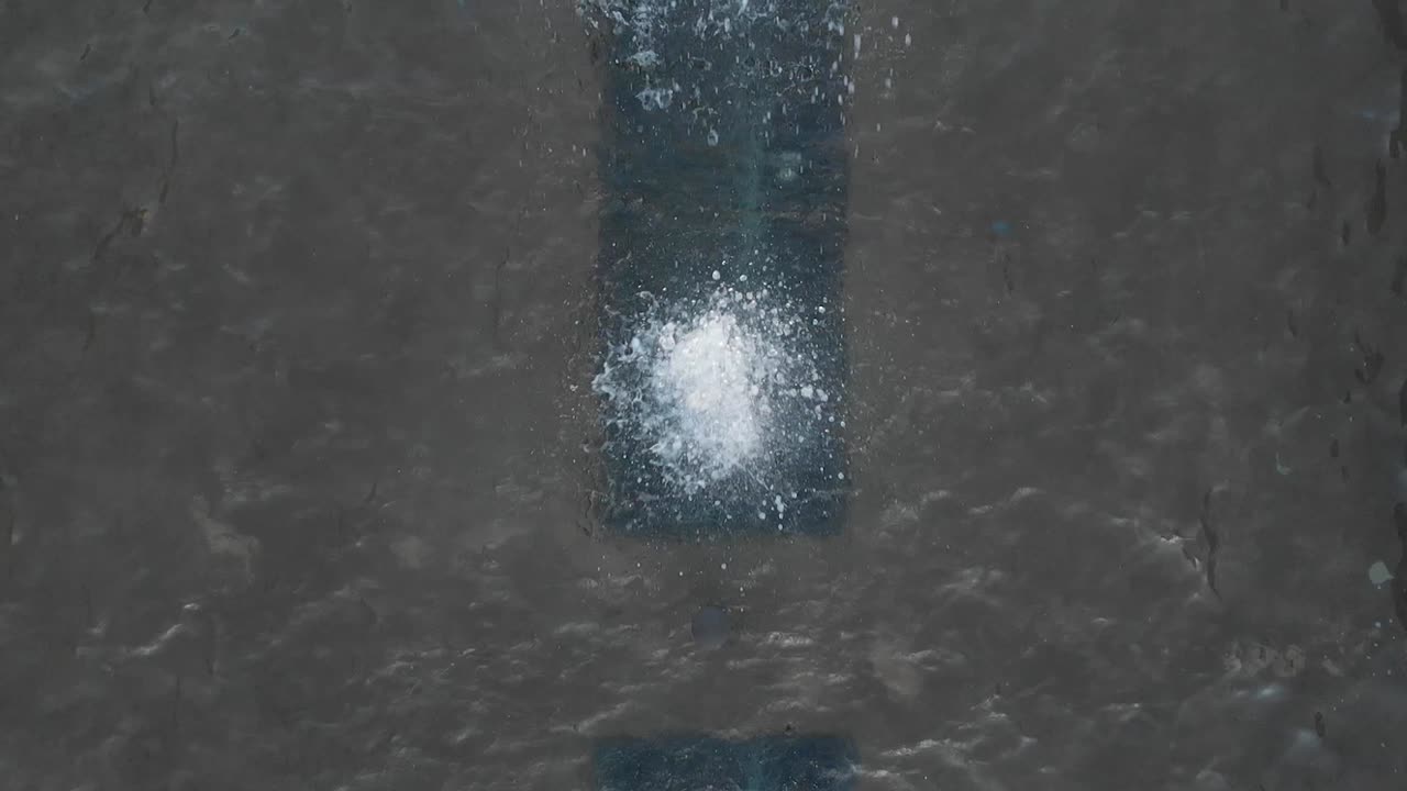 Small Water Fountain Squirting And Splashing From Below. - Top View Shot