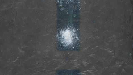 small water fountain squirting and splashing from below. - top view shot