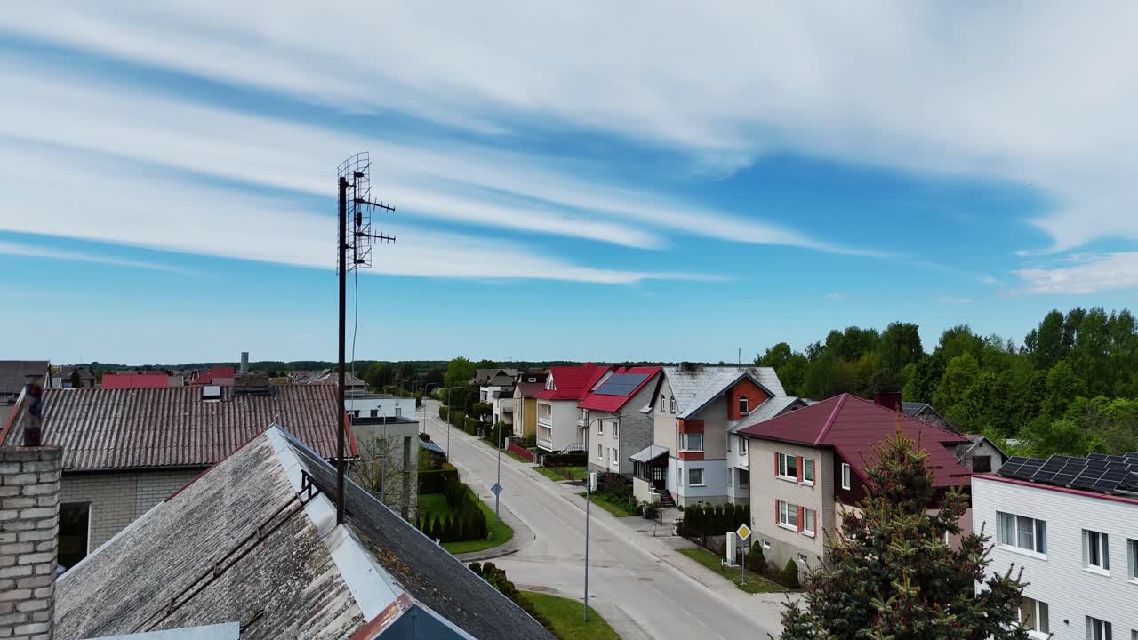 Suburban street with antennas on old houses and rooftops, aerial view
