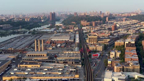 aerial trucking shot over industrial part of upper manhattan new york city at golden hour