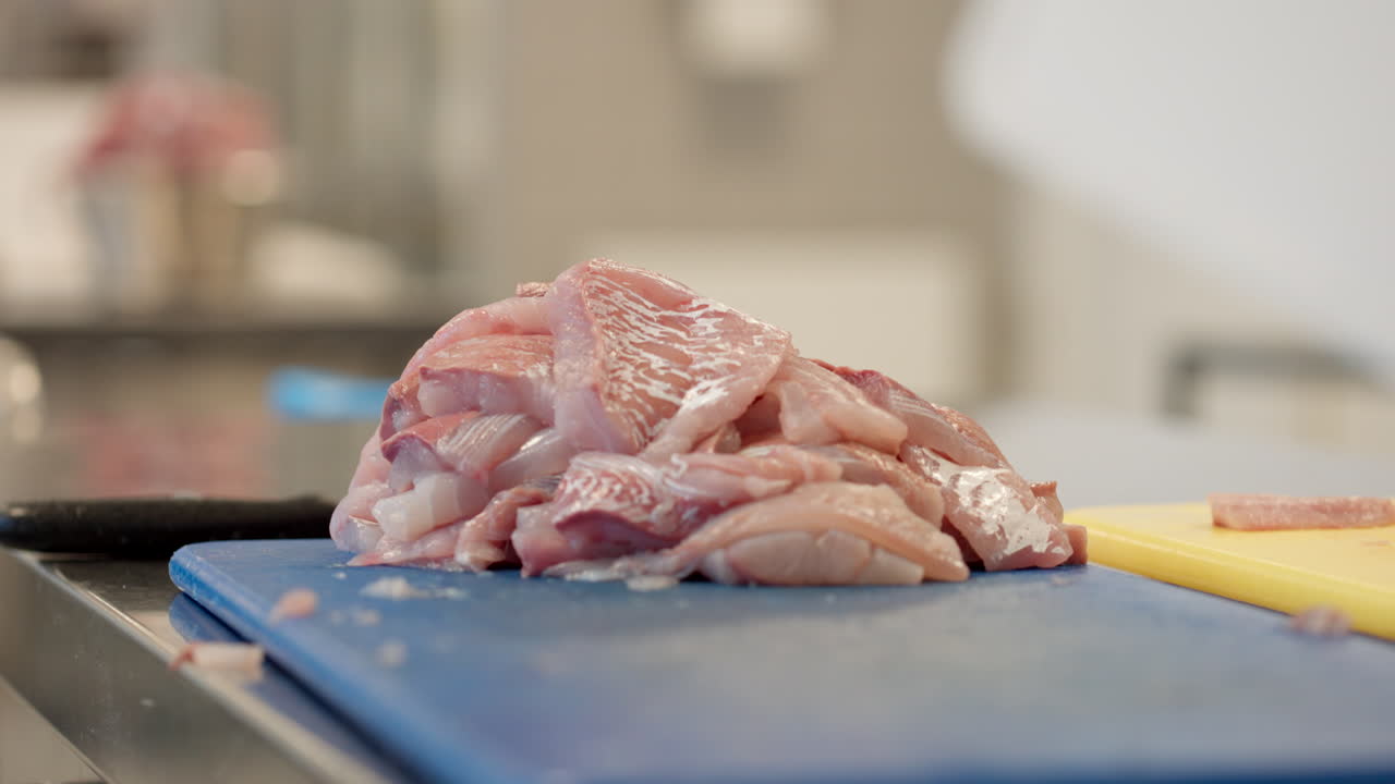 Fresh Uncooked Salted Herring Fish On Chopping Board In Kitchen. closeup shot