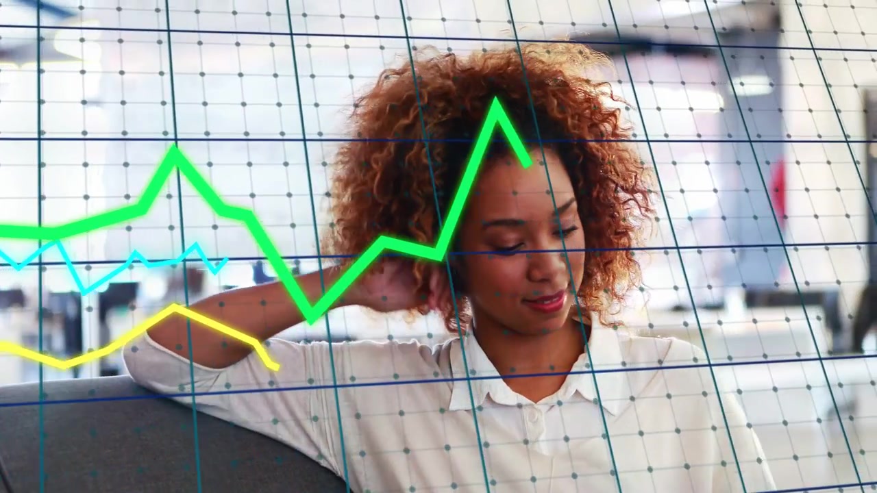 Woman tapping tablet in modern office and starting animated business graphs analyzing data