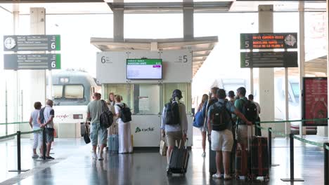 passengers waiting at barcelona sants train station