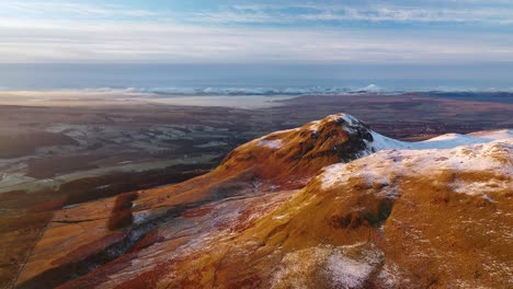 Cinematic-4K-Aerial-Approach-of-Snowy-Dumgoyne-Hill-on-The-Camspie-Fells