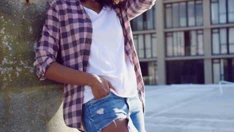 Fashionable-young-woman-on-urban-rooftop-admiring-the-view