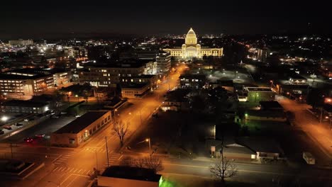 arkansas state capitol building at night in little rock, arkansas with drone video moving up at an angle