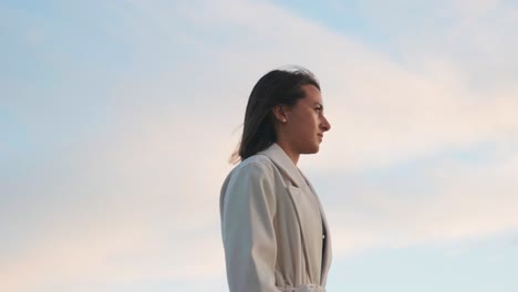 Low-angle-view-of-female-stature-against-evening-sky,-calm-outdoor-walk