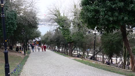 park path with people walking on a stone pathway