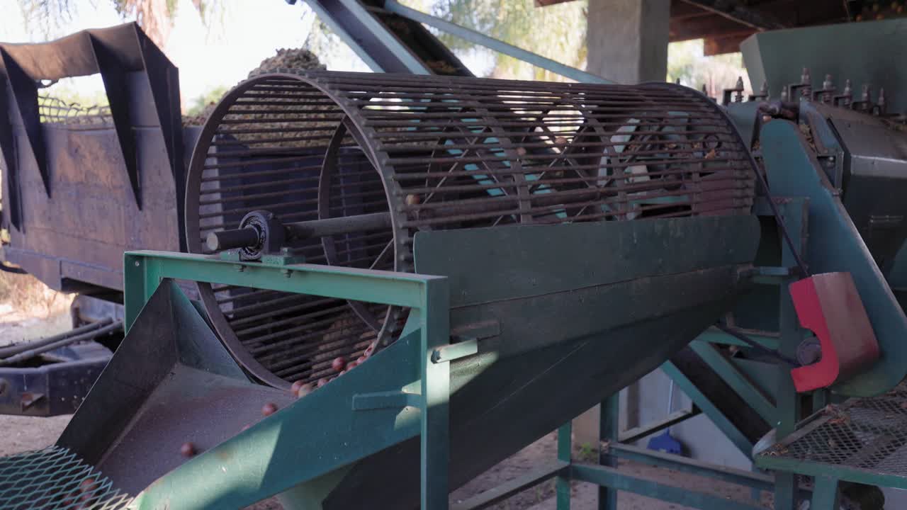 Food processing equipment: Large engine spins Macadamia nut tumbler