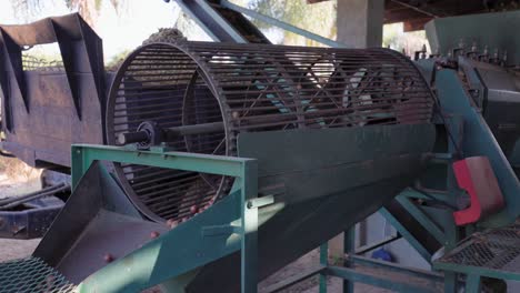 food processing equipment: large engine spins macadamia nut tumbler
