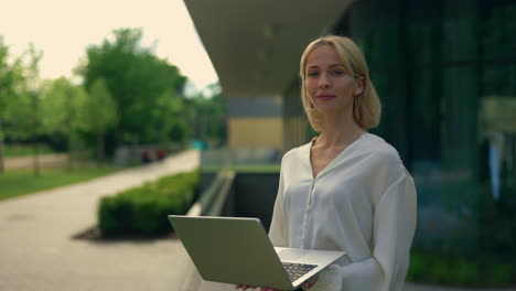 woman working outside with a laptop