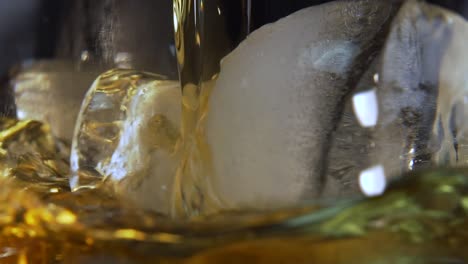 close up to ice cubes on which whisky is being served in a glass
