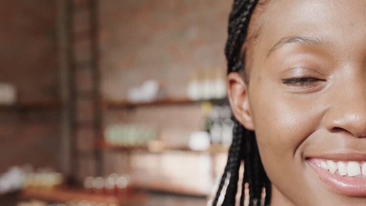 Half portrait of happy african american woman smiling at coffee shop, copy space, slow motion