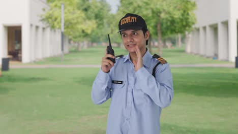 Indian-security-guard-giving-instructions-on-walkie-talkie