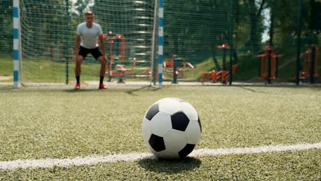 close up of soccer player's legs executing penalty kick and scoring a goal