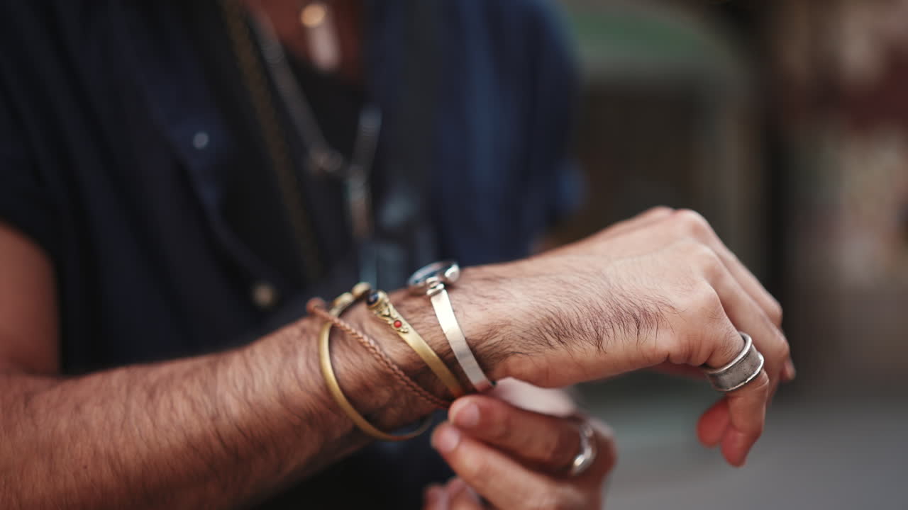 Close-up of Man's Hands Wearing Jewelry