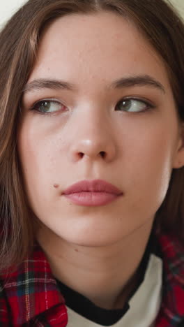 upset young woman looks aside in room closeup. sad long haired lady heard tragical news about relatives at home. dealing with depression disorder