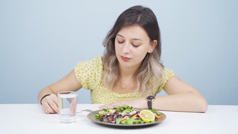 The-dieter-gets-tired-of-eating-salad.-A-person-struggling-with-a-diet.