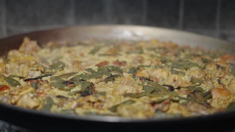 traditional paella cooking in a large pan