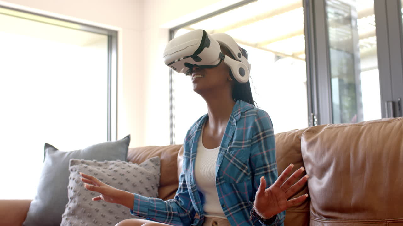 A young African American woman wearing virtual reality headset, exploring