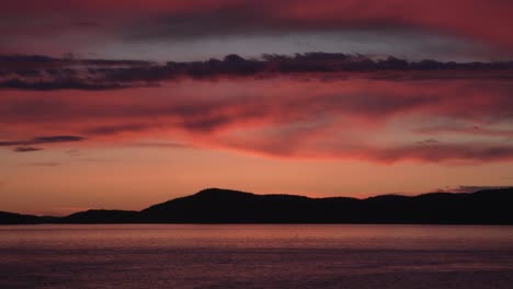 sunset over san juan islands with silhouette mountain in washington, usa. - wide