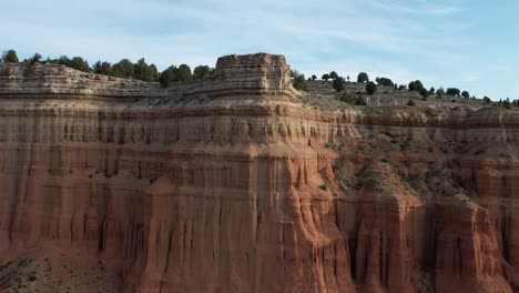 fordward drone flight view of a red canyon dessert in teruel, spain, at dawn