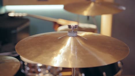 shiny crash cymbal from a drum kit during a music rehearsal session