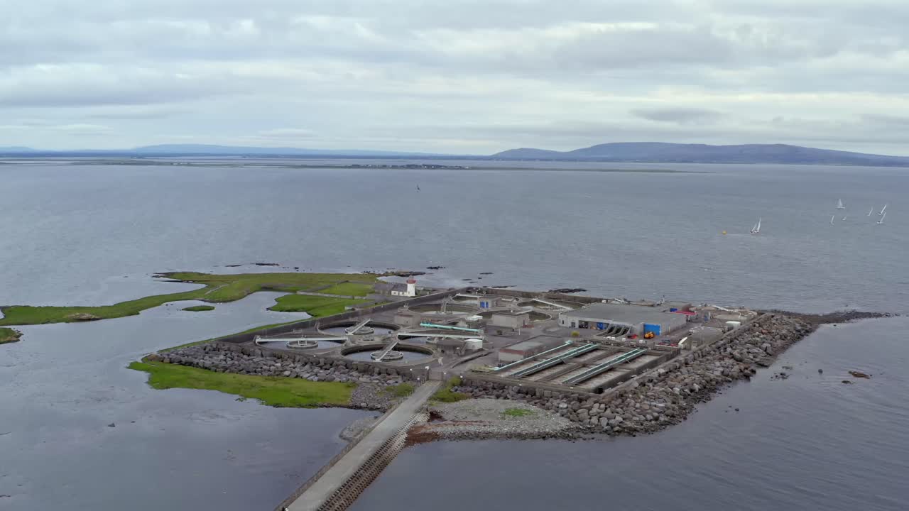 Aerial orbit of Mutton Island and its wastewater treatment plant in Galway Bay, Ireland