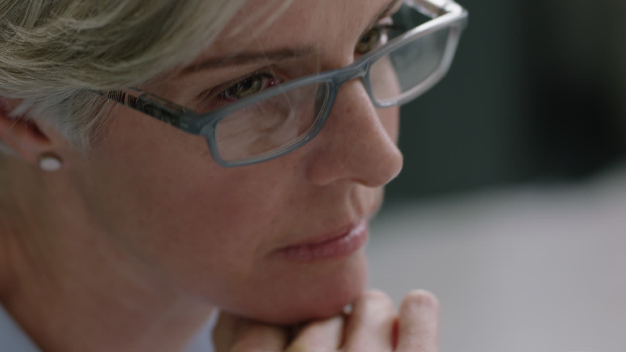 middle aged business woman manager talking to colleague sharing ideas collaborating on creative project smiling enjoying teamwork conversation in successful office meeting wearing glasses close up
