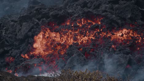 close-up of molten lava slowly flowing from grindavik volcano in sundhnúkur crater, iceland