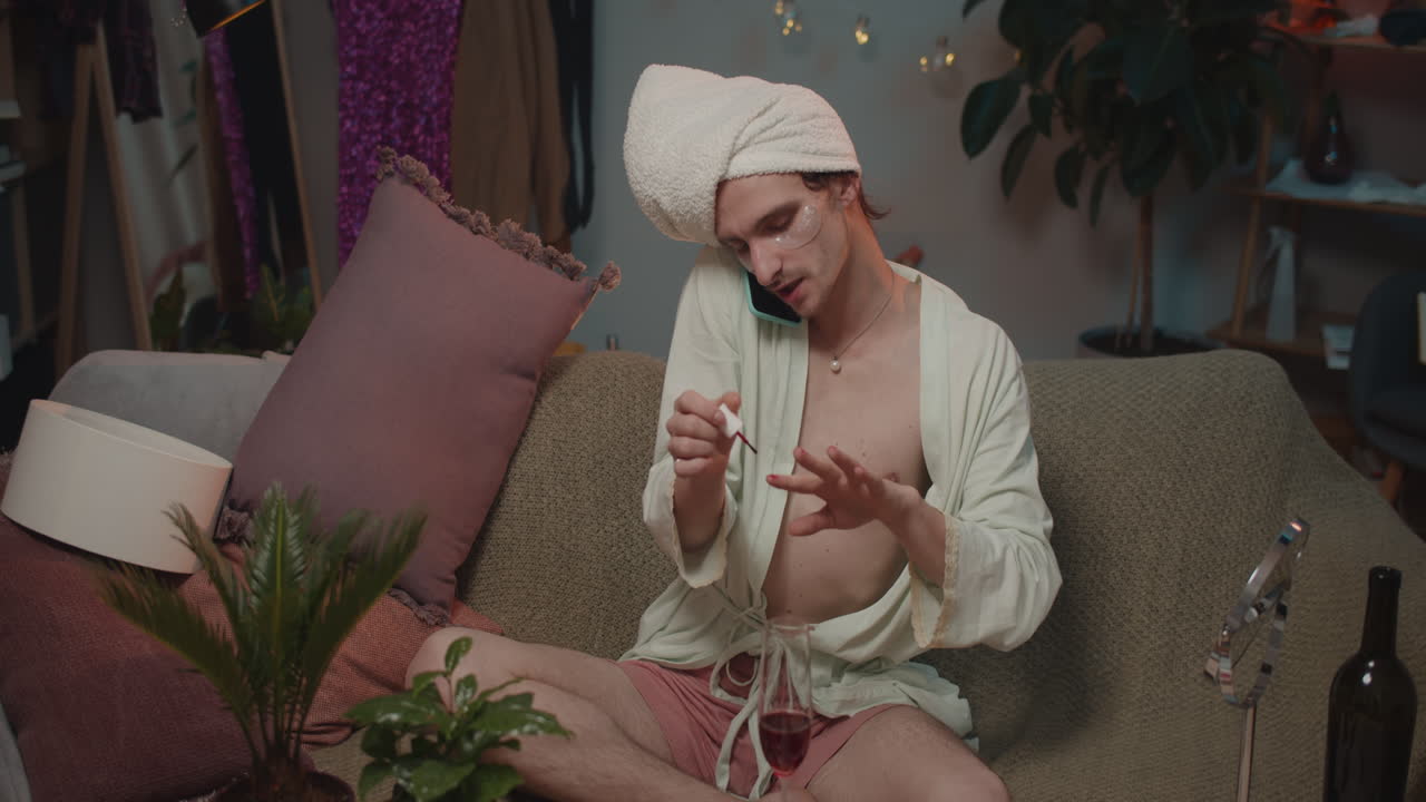 Man doing manicure and talking on the phone