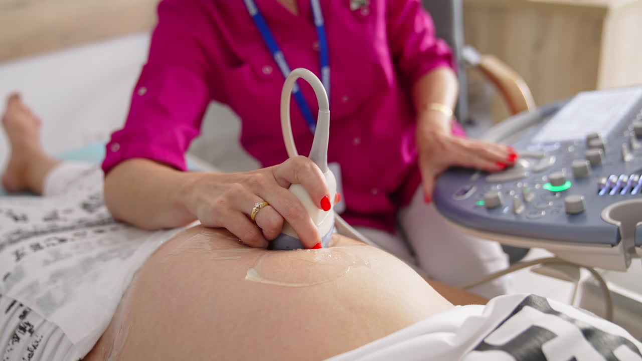 Pregnant woman getting ultrasound screening. Process of fetus ultrasonography. Pregnancy and Healthcare concept.