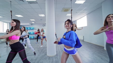People doing exercises in gym. Beautiful women working out in gym together