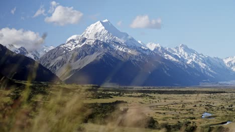 Beautiful-green-valley-with-majestic-mountains-above