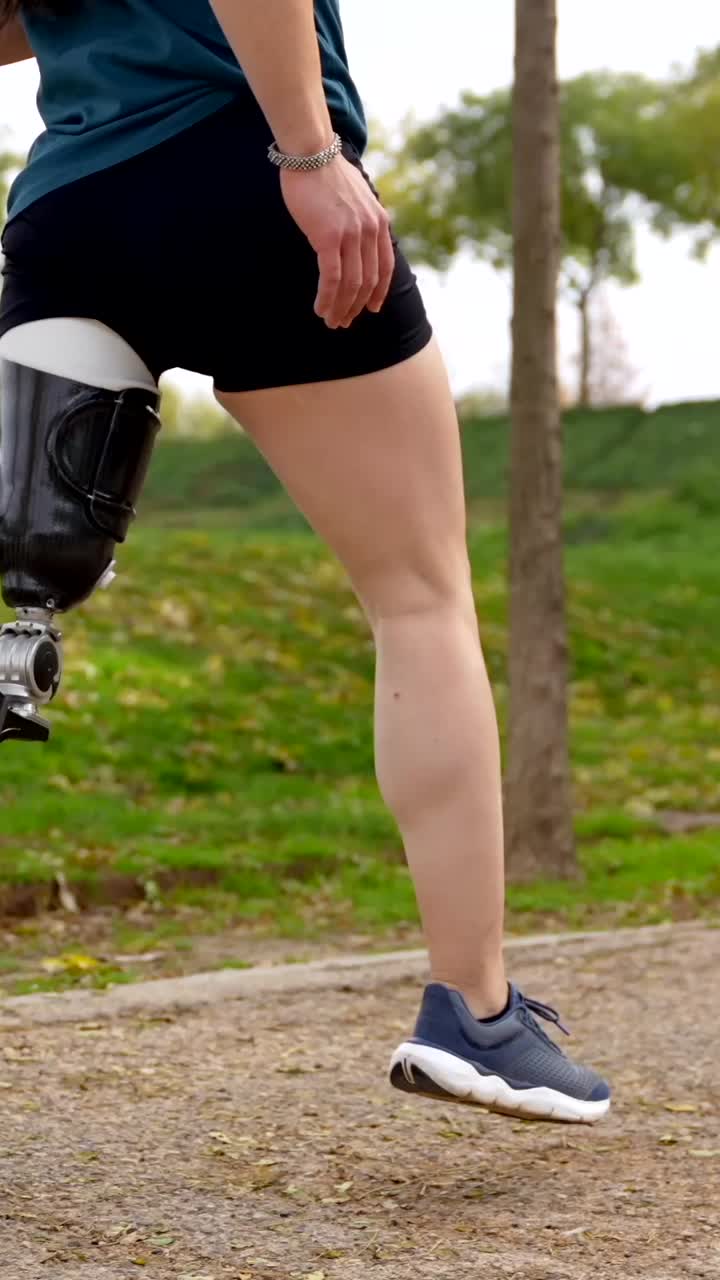 Woman with a prosthetic leg running outdoors