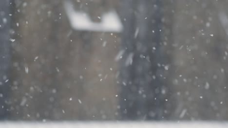 snow falling gently before a blurred background of a minster