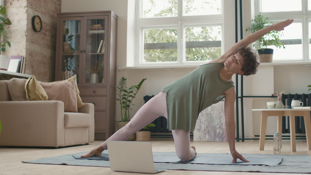 Woman practicing yoga at home