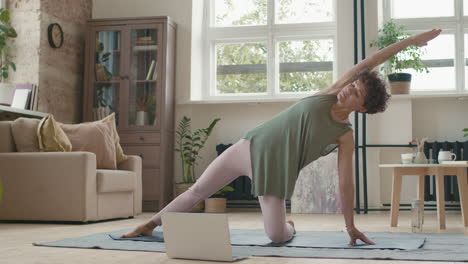 woman practicing yoga at home