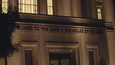 inscription above front doors of lds church "holiness to the lord - the house of the lord" | mormon temple at night in gilbert, arizona