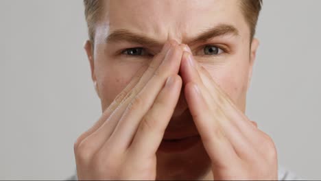 man covering his nose