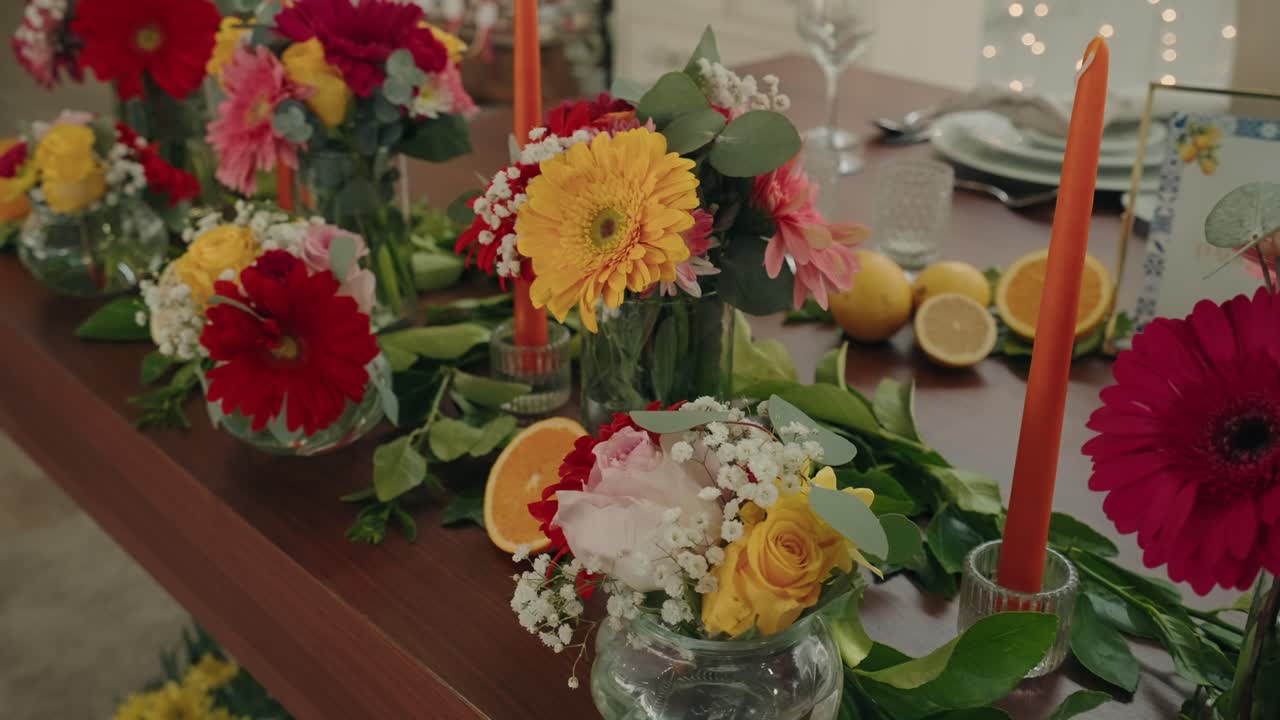 colorful flower arrangements with citrus slices on decorated table