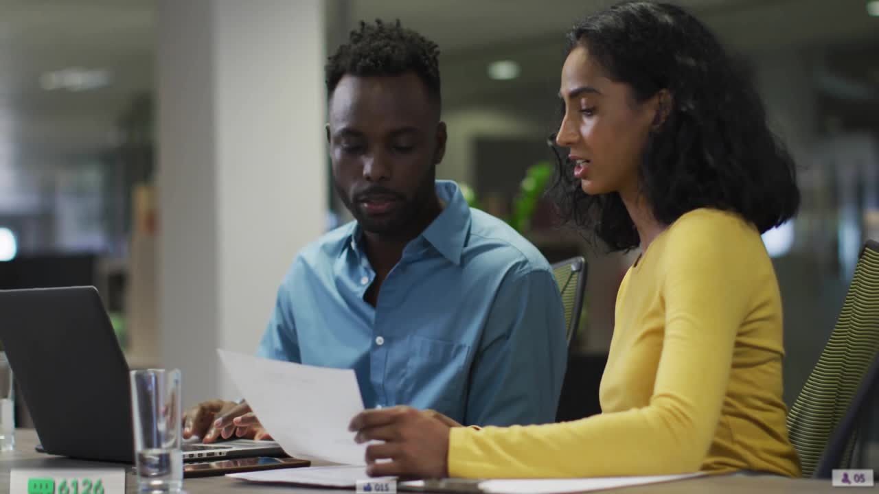 Woman reading report, man typing laptop causing analytics rising around team illustrating growth