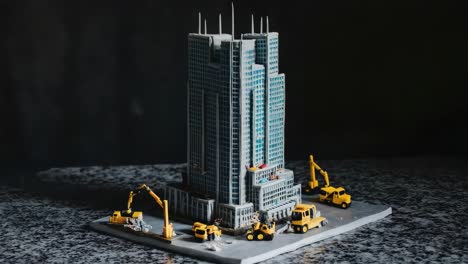 building model with construction vehicles